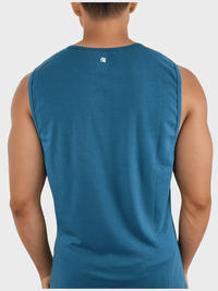 Blue sleeveless shirt worn by a person on a white background