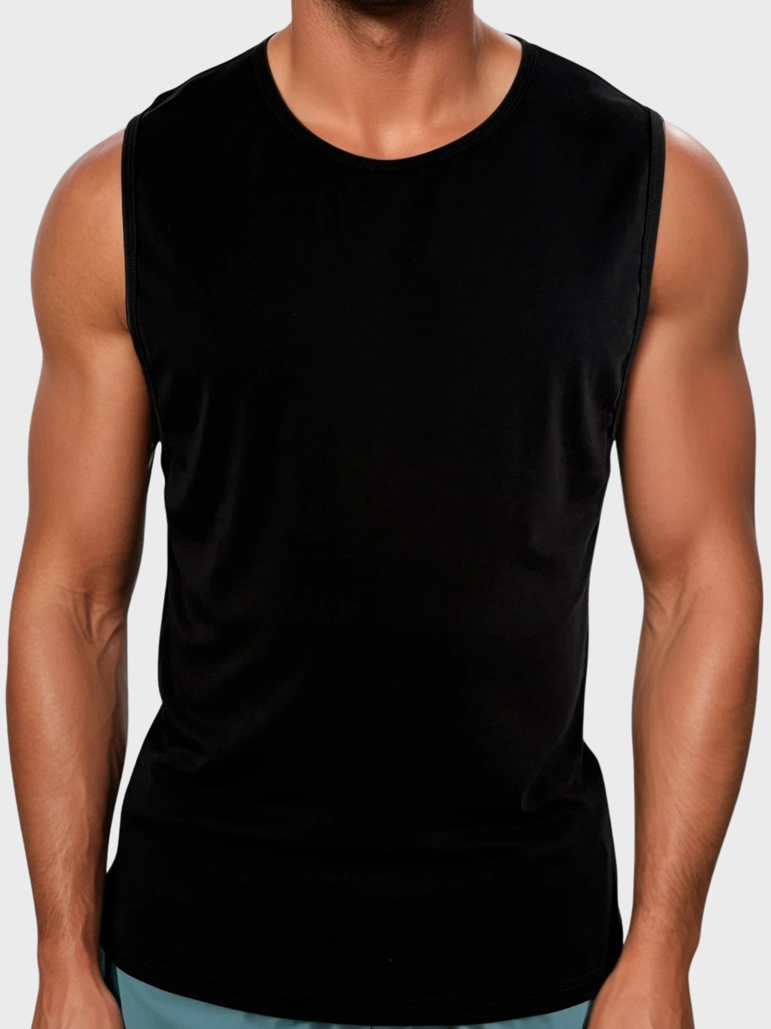 Person wearing a black sleeveless shirt on a plain background