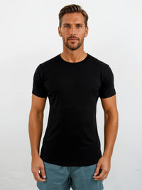Man wearing a black t-shirt against a plain background