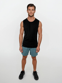 Man wearing a black sleeveless shirt and teal shorts on a white background