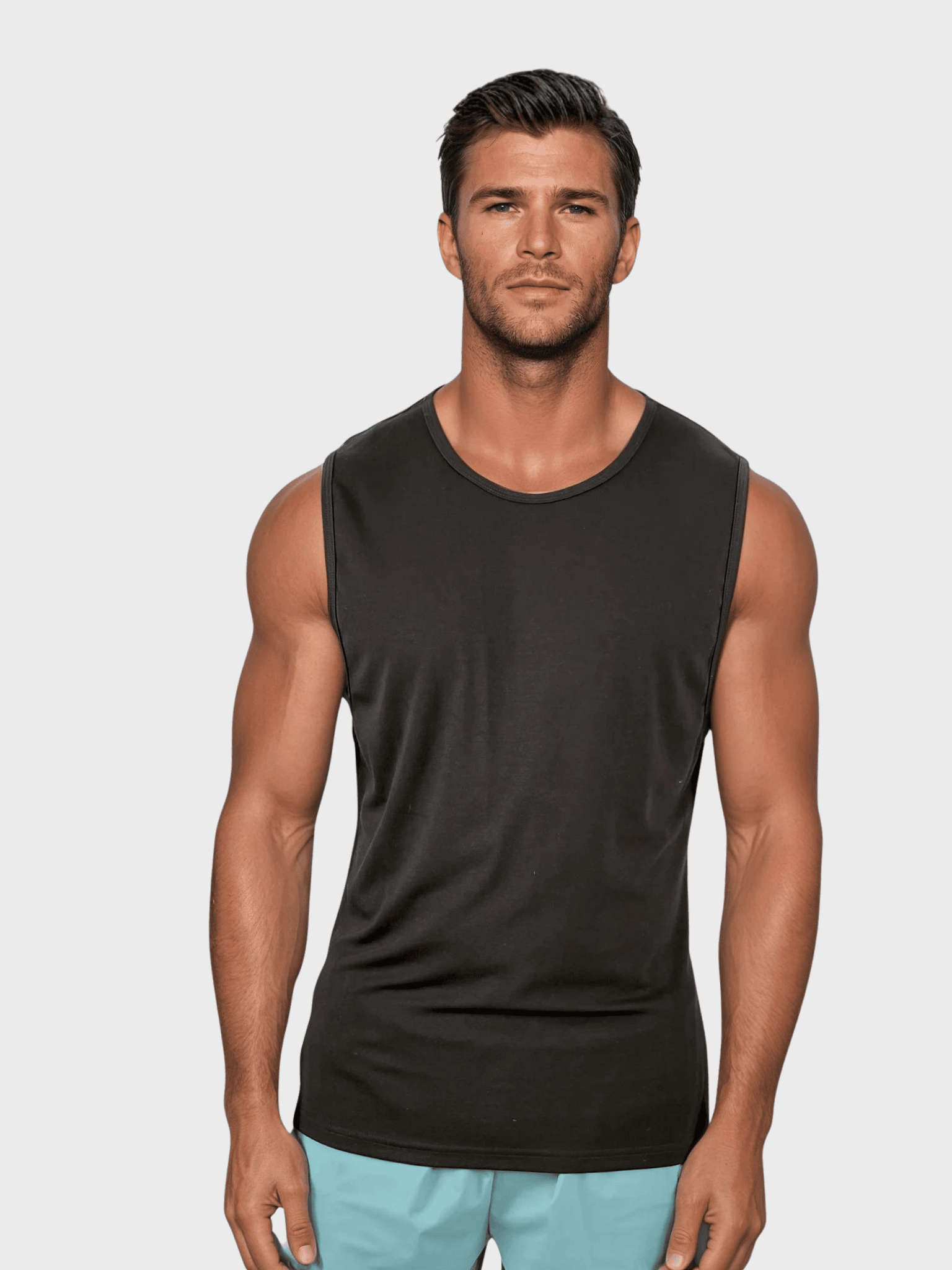 Man wearing a black sleeveless shirt against a plain background