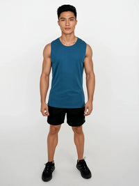 Man wearing a blue sleeveless shirt and black shorts on a white background